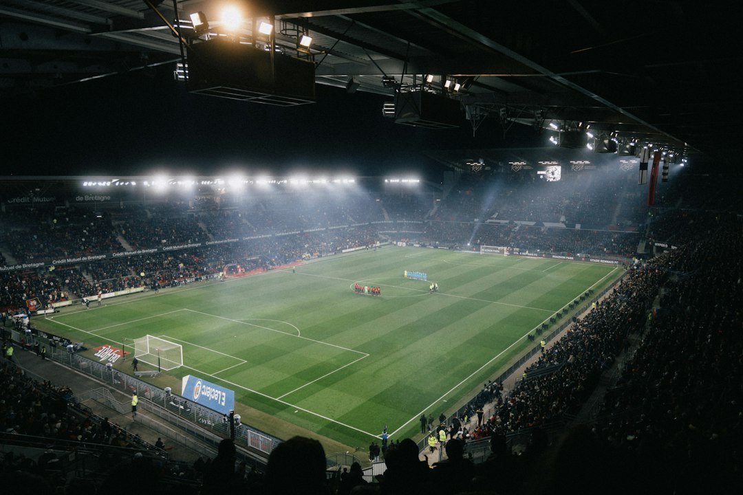 Floodlit football pitch with players during a European night match, illustrating the Man City vs PSG team news