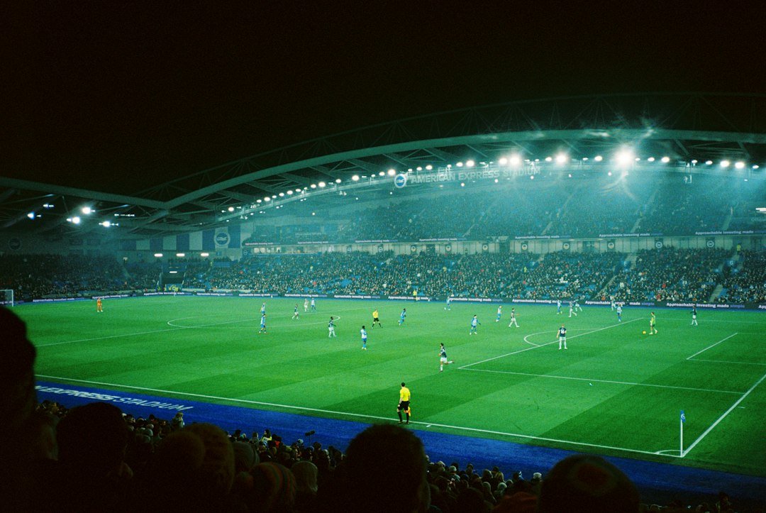 Football stadium at night lit up for a big international match, like Messi's farewell at the Monumental