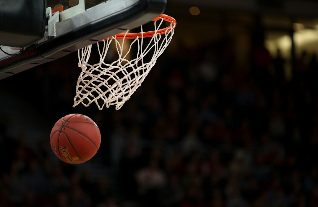 Basketball player shooting the ball toward the hoop during a game