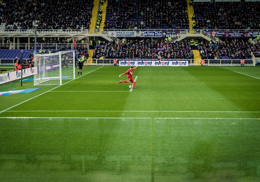 Football flying toward the goal net in a dramatic goal moment
